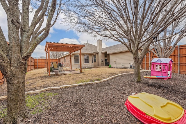 rear view of house with a fenced backyard, a patio area, a chimney, and a pergola