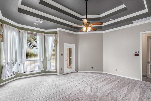 unfurnished room featuring carpet floors, a healthy amount of sunlight, visible vents, and a tray ceiling