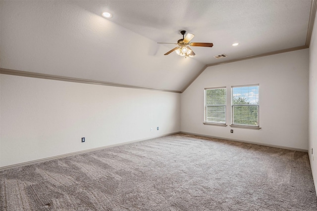 additional living space featuring lofted ceiling, carpet, visible vents, and ceiling fan