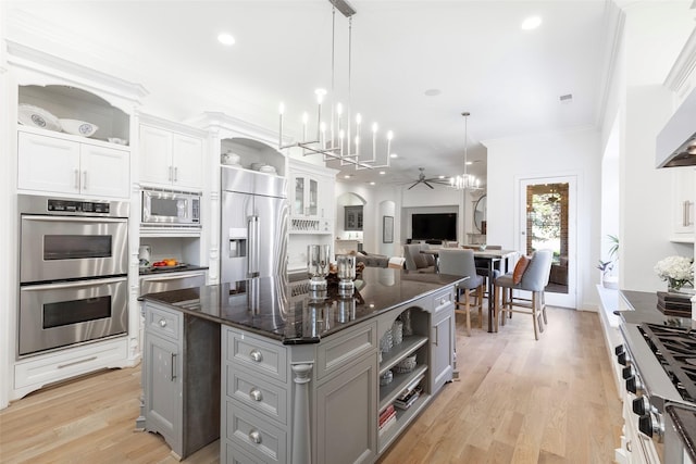 kitchen featuring gray cabinets, appliances with stainless steel finishes, open shelves, and crown molding