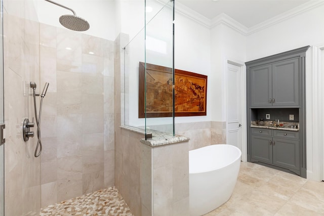 bathroom featuring a freestanding tub, ornamental molding, a walk in shower, and tile walls