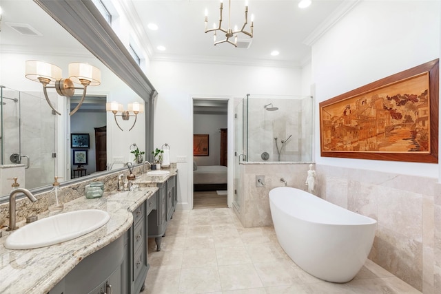 ensuite bathroom featuring a stall shower, crown molding, and a sink