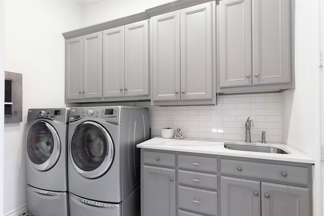 laundry area with a sink, cabinet space, and washer and dryer