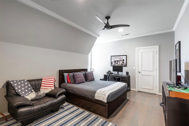 bedroom with wood finished floors, visible vents, baseboards, a ceiling fan, and ornamental molding