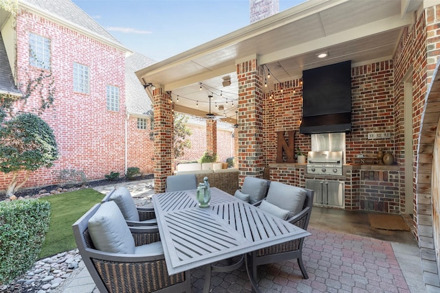 view of patio / terrace featuring grilling area, exterior kitchen, and an outdoor living space