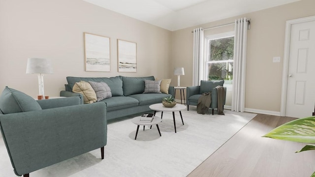 living area with baseboards and wood finished floors