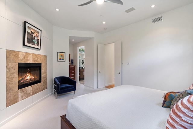 bedroom with recessed lighting, a tiled fireplace, and a ceiling fan