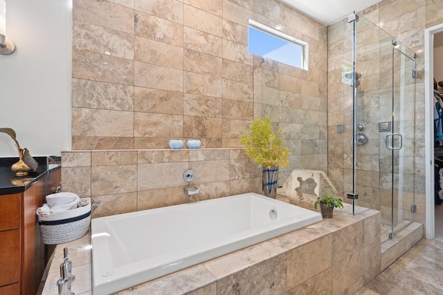 full bathroom featuring a shower stall and a garden tub