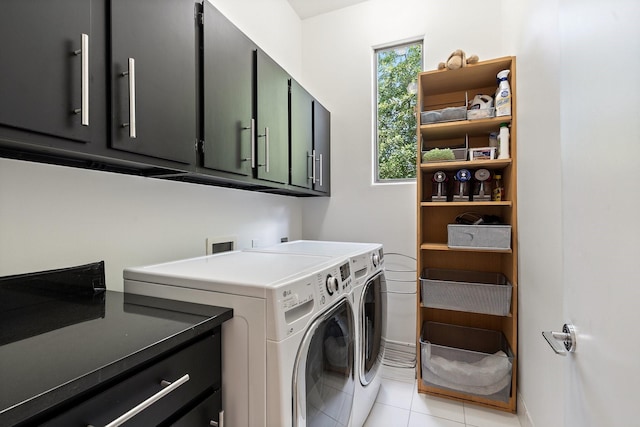 laundry room with cabinet space, washer and dryer, light tile patterned flooring, and baseboards