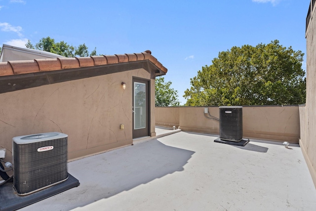 view of patio featuring central AC unit and fence