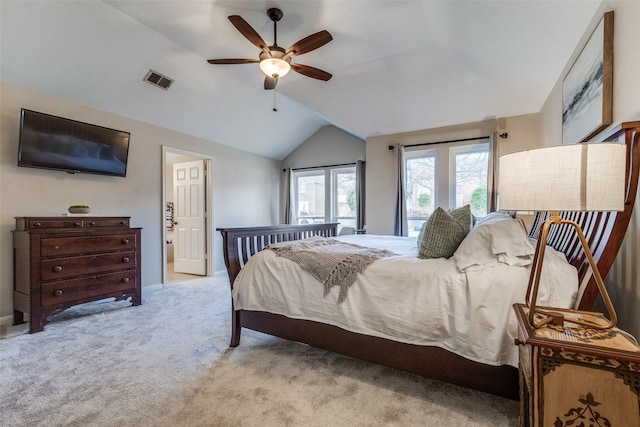 carpeted bedroom featuring lofted ceiling, ceiling fan, visible vents, and baseboards