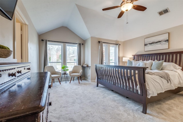 carpeted bedroom featuring baseboards, visible vents, vaulted ceiling, and a ceiling fan