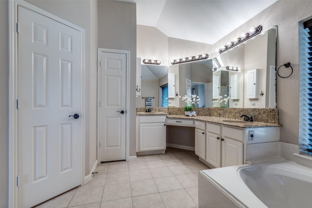 full bathroom featuring a bathtub, lofted ceiling, vanity, and tile patterned floors