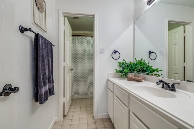 bathroom with a shower with curtain, vanity, baseboards, and tile patterned floors