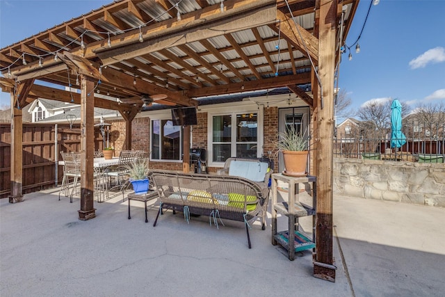 view of patio with fence, area for grilling, and outdoor dining space