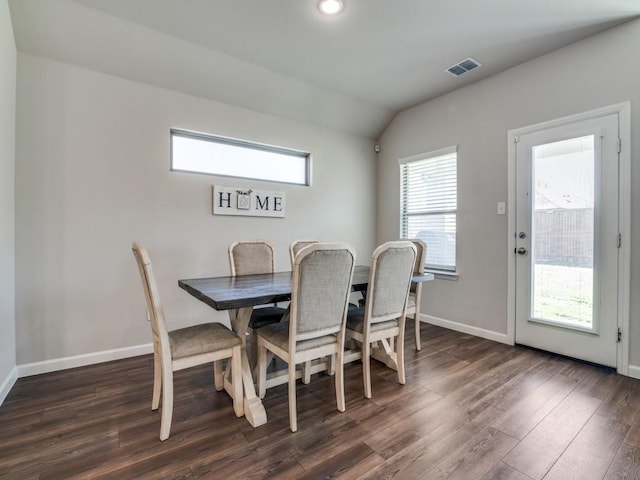 dining area featuring vaulted ceiling, visible vents, dark wood finished floors, and baseboards