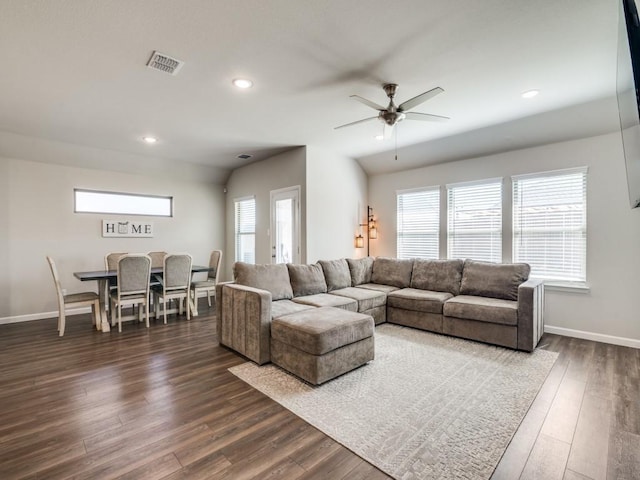 living room featuring recessed lighting, dark wood finished floors, visible vents, and baseboards