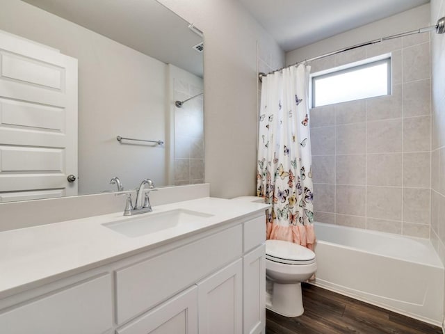 bathroom featuring toilet, shower / bath combo, wood finished floors, and vanity