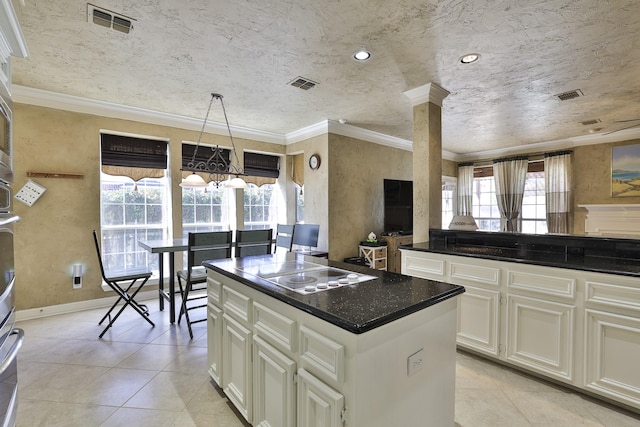 kitchen with visible vents, electric stovetop, and crown molding