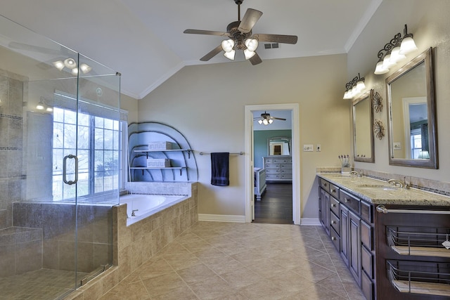 bathroom featuring a garden tub, double vanity, lofted ceiling, a stall shower, and a sink