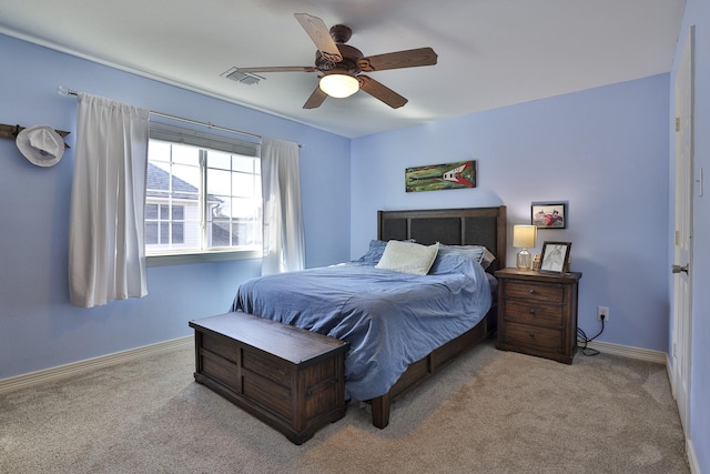 bedroom with a ceiling fan, light carpet, visible vents, and baseboards