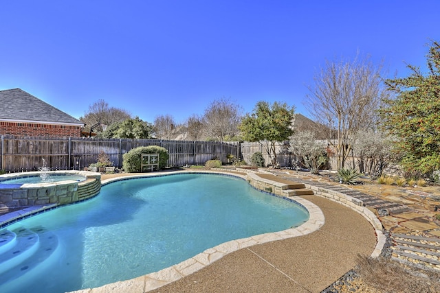 view of swimming pool featuring a fenced backyard and a pool with connected hot tub