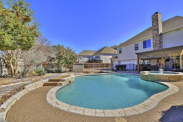 view of pool with a patio area, a fenced backyard, and a pool with connected hot tub