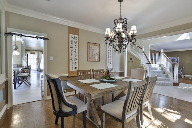 dining area featuring a notable chandelier, crown molding, stairs, and wood finished floors