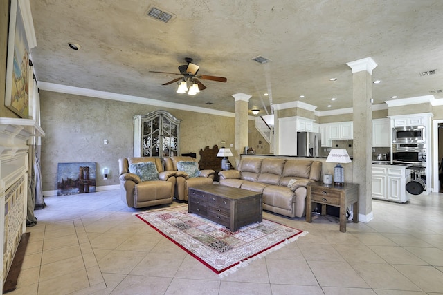 living room featuring light tile patterned floors, visible vents, and ornate columns