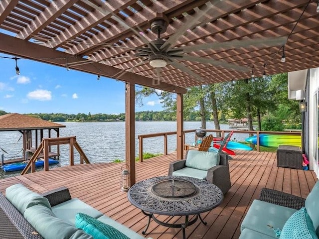 view of dock featuring a deck with water view, outdoor lounge area, and a pergola