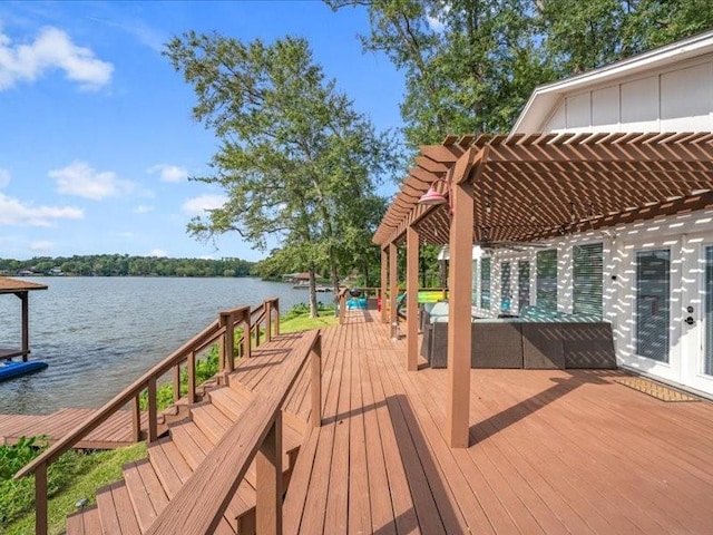 wooden terrace featuring a water view and a pergola