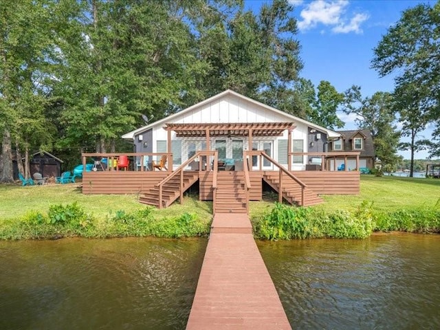 exterior space with a deck with water view, a yard, and stairway