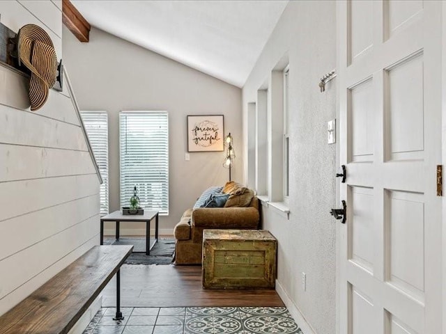 entryway with baseboards, vaulted ceiling, and wood finished floors