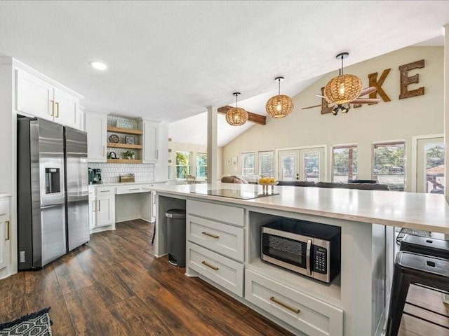 kitchen featuring a kitchen breakfast bar, stainless steel appliances, light countertops, white cabinetry, and open shelves