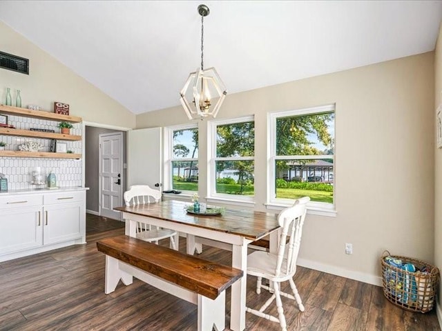 dining area featuring dark wood finished floors, a notable chandelier, visible vents, vaulted ceiling, and baseboards