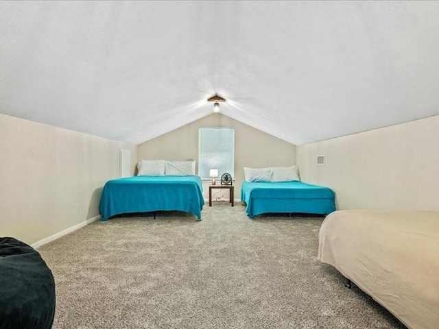 bedroom with carpet floors, baseboards, and vaulted ceiling