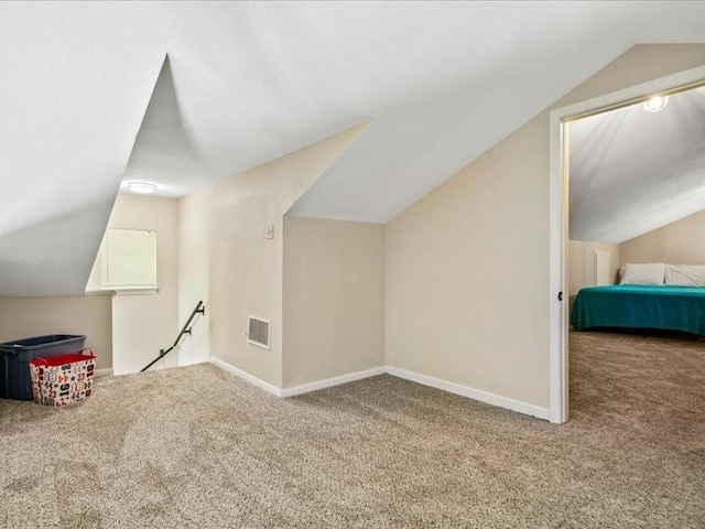 bonus room featuring vaulted ceiling, carpet floors, visible vents, and baseboards