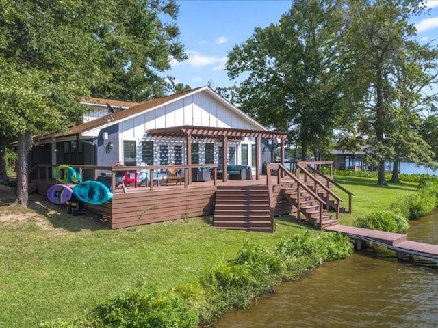 back of property featuring a lawn, stairway, board and batten siding, a deck with water view, and a pergola