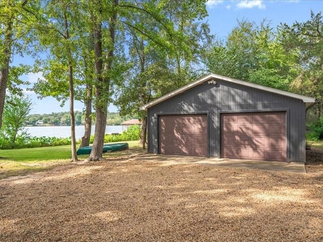 detached garage featuring a water view