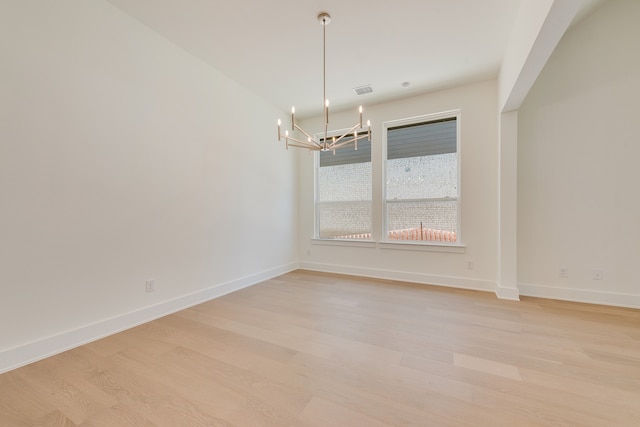 830 Montrose Dr, Rockwall, TX 75087 - spare room with a chandelier and light wood-style floors