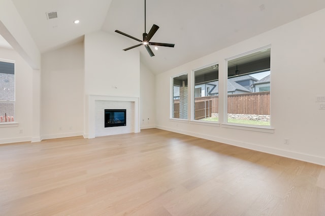 830 Montrose Dr, Rockwall, TX 75087 - unfurnished living room featuring light wood-style flooring, a glass covered fireplace, a ceiling fan, high vaulted ceiling, and recessed lighting
