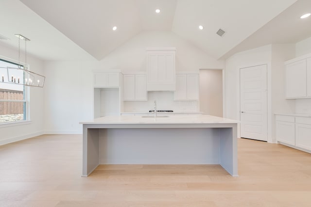830 Montrose Dr, Rockwall, TX 75087 - kitchen featuring white cabinets, backsplash, a large island with sink, light wood-type flooring, and recessed lighting