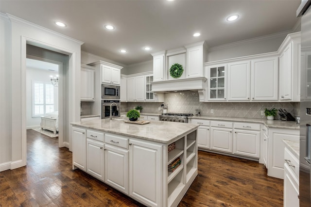 kitchen with dark wood-style floors, appliances with stainless steel finishes, and white cabinets