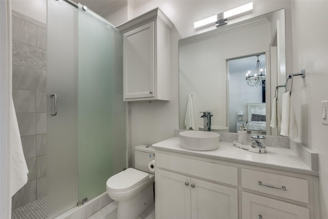 bathroom with a stall shower, vanity, and toilet