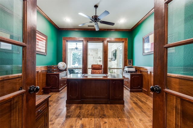 office with dark wood-style floors, ornamental molding, and wainscoting