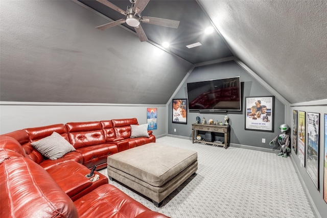 carpeted cinema featuring lofted ceiling, a textured ceiling, a ceiling fan, and baseboards