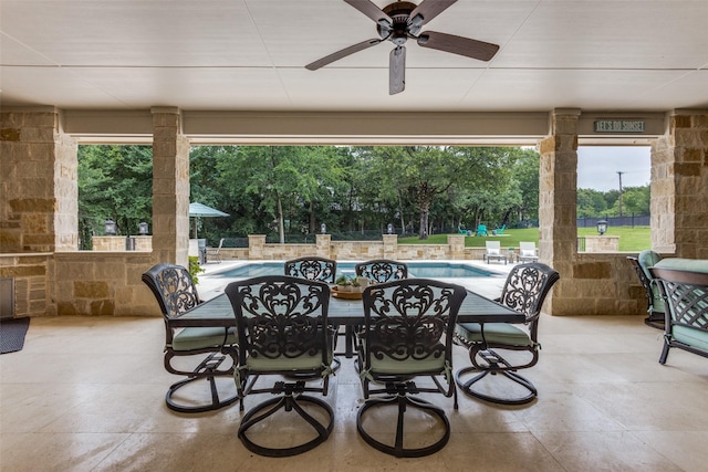 view of patio / terrace with a ceiling fan, outdoor dining area, and an outdoor pool