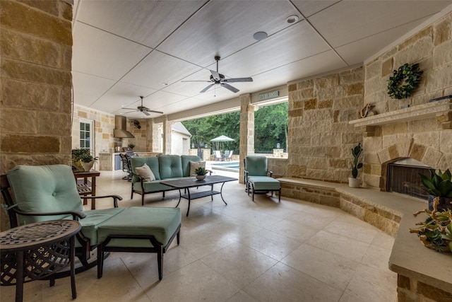 view of patio / terrace featuring a ceiling fan, an outdoor pool, and an outdoor living space with a fireplace