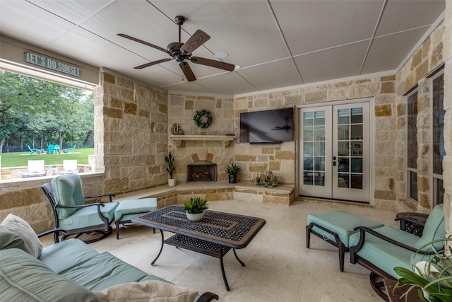 exterior space featuring ceiling fan, french doors, and a stone fireplace