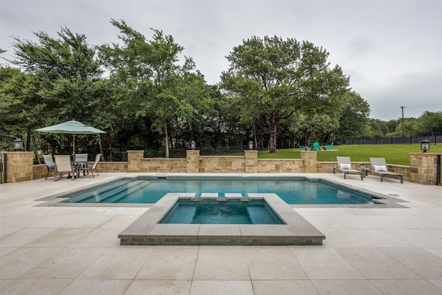 view of pool featuring a pool with connected hot tub, a patio area, and fence